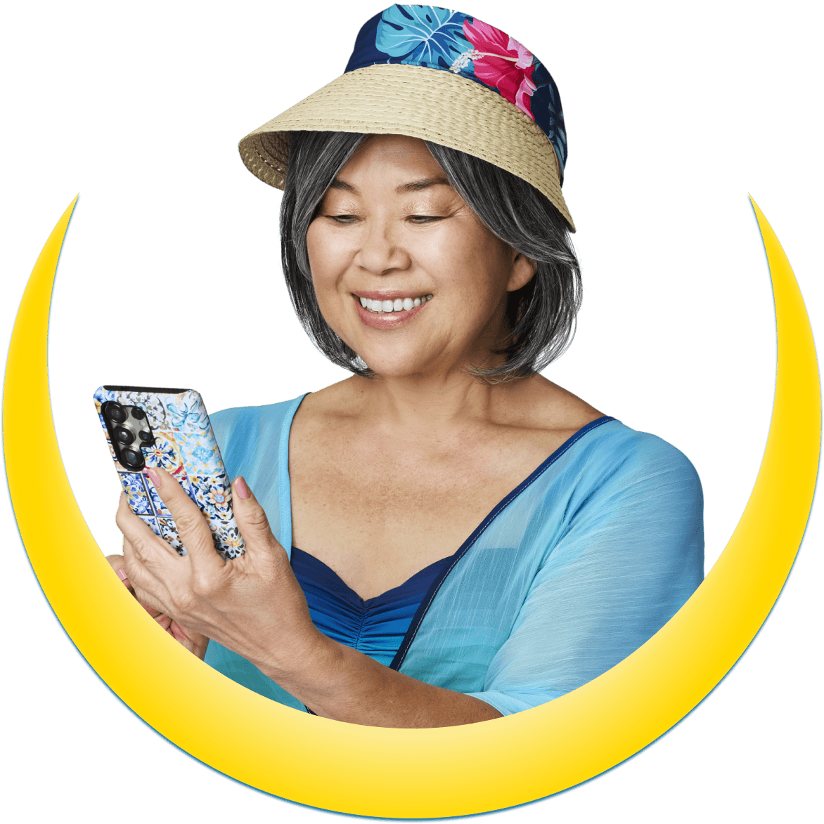 A woman holding a mobile phone and wearing a hat